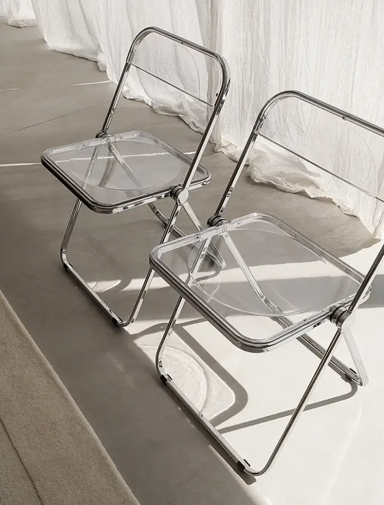 Two transparent folding chairs in a minimal studio setting — representing Go Social Studios’ collaborative and no-nonsense agency approach.