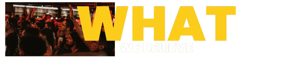Crowd of creative professionals at an event, overlaid with bold yellow text “WHAT WE BELIEVE” — expressing Go Social Studios’ creative philosophy.